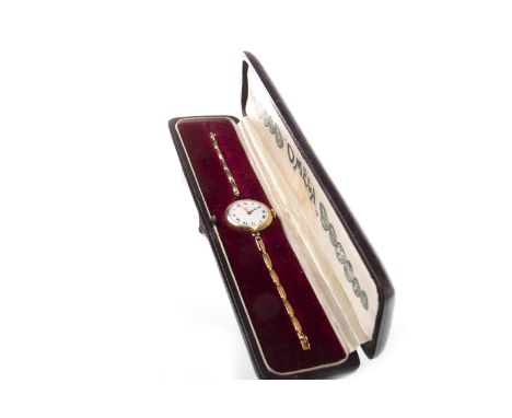 LADY'S OMEGAEARLY TWENTIETH CENTURY MANUAL WIND WRIST WATCH, the round white dial with Roman numerals in black, twelve in red