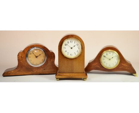 An Edwardian inlaid mahogany dome topped mantle clock, 22cm high together with two inlaid mahogany mantle clocks, each raised