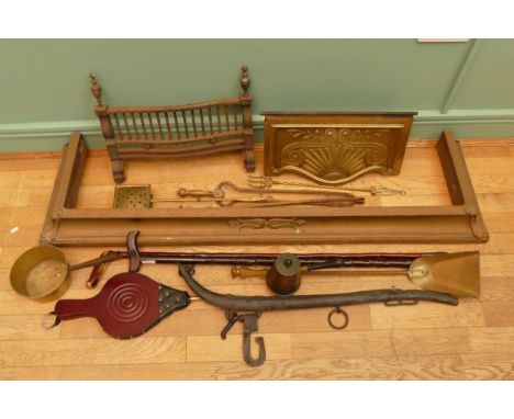 An Art Nouveau brass fire fender, W139cm, together with associated fire grate front, fireside irons, a brass chestnut roaster