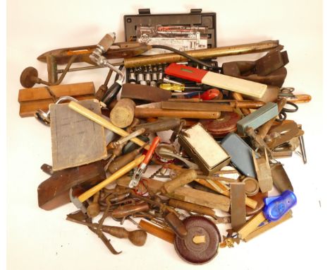 A collection of early 20th century and later carpenters hand tools, to include box planes, Stanley planes, drills, rulers, an