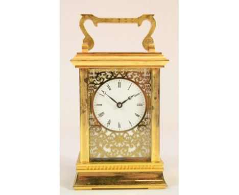 A late 20th century brass English brass corniche cased carriage clock, the dial with black Roman numerals and pierced decorat