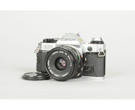 A Canon AE-1 Program SLR Camera, chrome, serial no. 2494622, shutter working, Canon "squeak", body G-VG, with a Canon FD 35mm