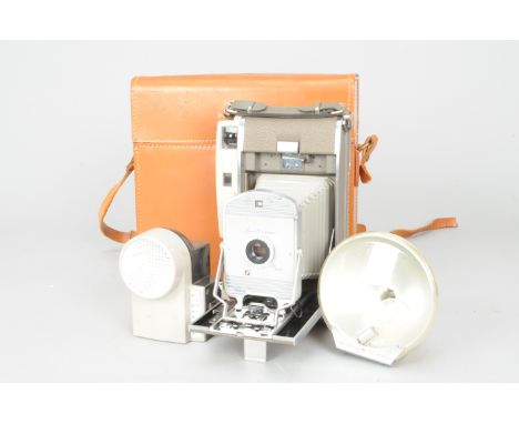 A Polaroid 800 Folding Land Camera, with Polaroid BC Flash bulb holder, a Polaroid Wink-Light, a Bounce Flash Bracket Model 2