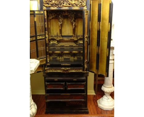 Early 20th Century Chinese Brass Mounted Lacquered and Gilt Wood Two Part Altar Cabinet with Finely Carved Fitted Interior. U