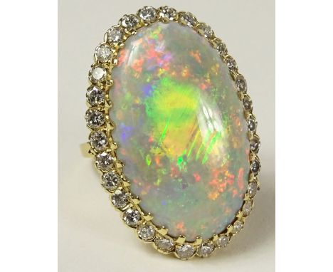 Ladies Fine Opal, 18 Karat Yellow Gold and Diamond Ring. The 19.25 Carat Center Stone with Lots of Fire, Surrounded By Approx