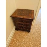 A Regency Style Walnut And Flame Veneered Chest Of Drawers Fitted With Four Drawers Fitted With Swan