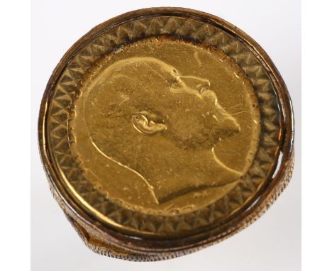 An Edward VII 1907 gold half sovereign coin ring, in 9ct textured mount, setting height 22.1mm, size N, 7.1gNo damage or repa