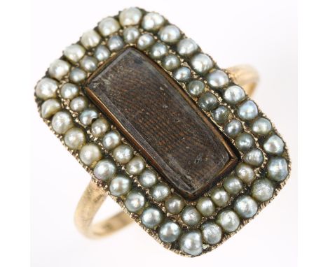 A large Georgian split pearl memorial panel ring, unmarked gold settings with central vacant panel under curved glass with do