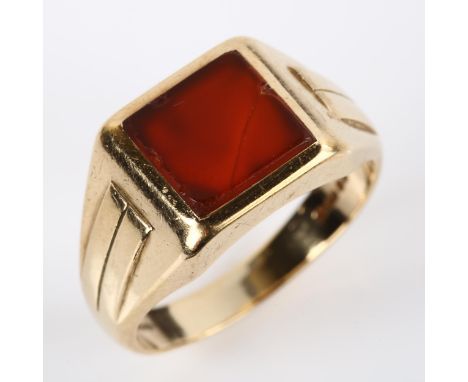 A large 9ct gold carnelian signet ring, setting height 12.4mm, size W, 10.5gCarnelian has a few edge chips and 1 diagonal cra