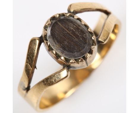 A Georgian hair panel memorial ring, unmarked gold closed-back settings, with panel under glass crystal, setting height 9.1mm