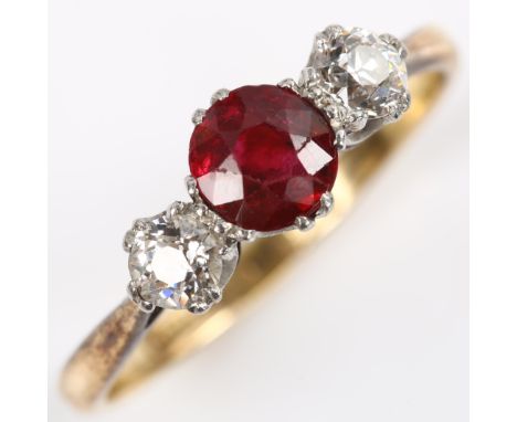 An early 20th century 18ct gold three stone garnet and diamond ring, set with round-cut garnet and old European-cut diamonds,