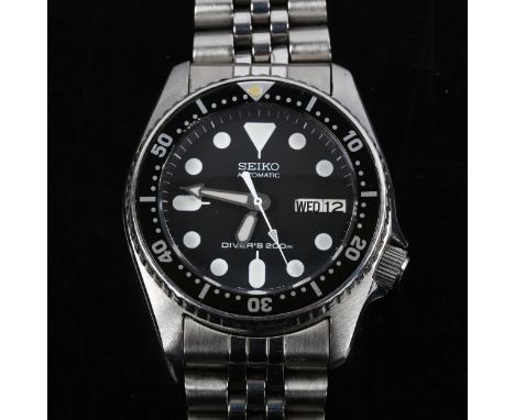 SEIKO - a stainless steel Diver's 200M automatic bracelet watch, ref. 7S26-0030, black dial with luminous dot and baton hour 