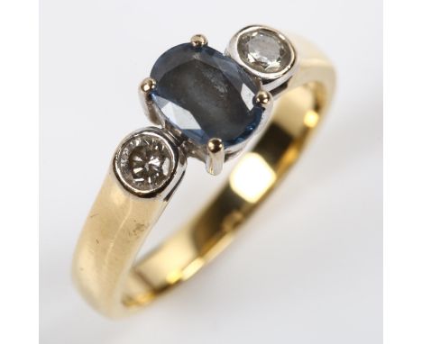 An 18ct gold three stone sapphire and diamond ring, set with oval mixed-cut sapphire and modern round brilliant-cut diamonds,