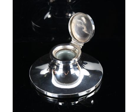 A George V silver Capstan inkwell, by William Neale & Sons, hallmarks Birmingham 1928, diameter 11.5cm, loaded baseA few very