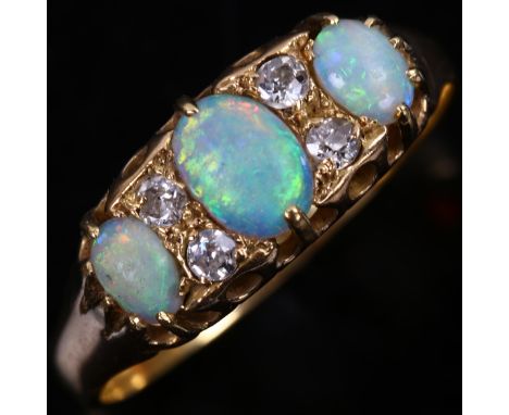 An 18ct gold seven stone opal and diamond half hoop ring, set with oval cabochon opal and old and modern round brilliant-cut 