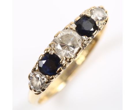 A 9ct gold graduated five stone cubic zirconia and sapphire half hoop ring, setting height 4.8mm, size M, 2.2gNo damage or re