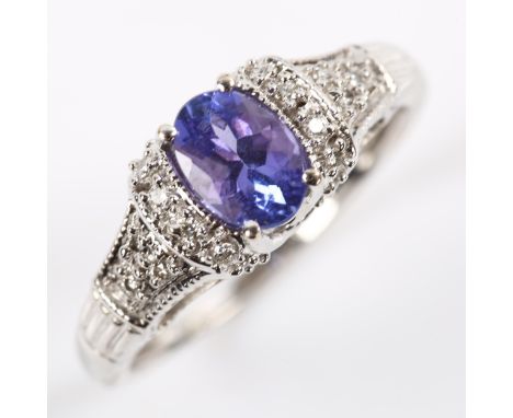 A modern 18ct white gold tanzanite and diamond dress ring, set with oval mixed-cut tanzanite and modern round brilliant-cut d