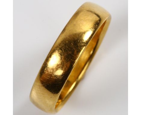 An early 20th century 22ct gold wedding band ring, hallmarks Birmingham 1911, band width 4.4mm, size L, 4.3gNo damage or repa