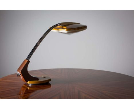 A 1960s EXECUTIVE LAMP, CONTINENTAL, the adjustable head with a chrome tubular support, on a circular swivel base, 46cm high