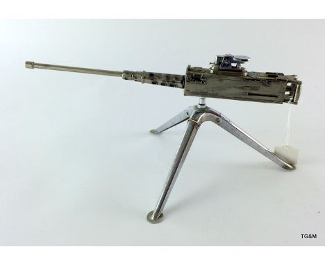 A very unusual table lighter in the form of an American Browning M2 machine gun on its tripod 31cms long by 15cms high