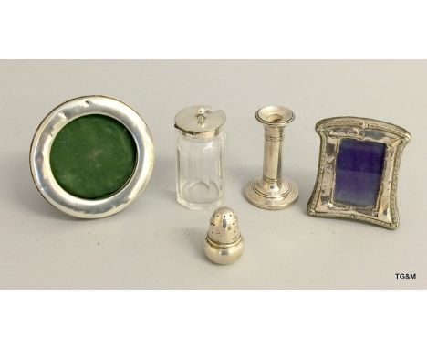 Silver curios to include picture frames, glass bottle and salt and candle stick which weigh together 49 grams