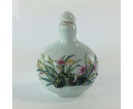 A ceramic Chinese perfume bottle decorated with a floral spray bearing signature