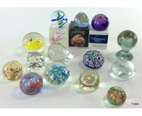 A collection of glass paperweights to include boxed Caithness