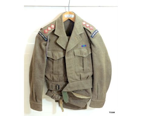 An Army military battle dress uniform 1949 pattern to include lanyard and whistle