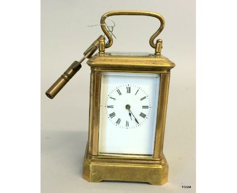 A miniature brass cased carriage clock and key
