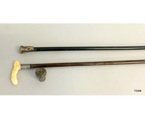 A silver topped walking stick, an ivory and silver topped walking stick and a silver top for a walking stick