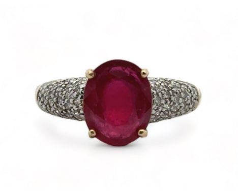 A 9ct yellow gold ring set with a central ruby and diamond shoulders. Size N. Weight 3.8g. In excellent condition. Please see