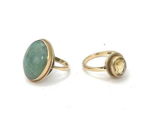 Two hallmarked 9ct gold rings. A ring set with an oval jade cabochon size N, and a yellow quartz ring size P. Total weight 9.