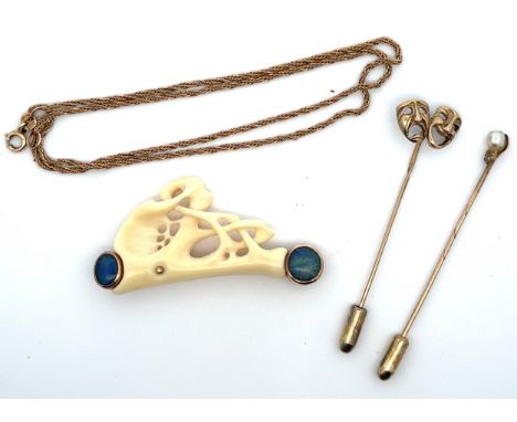 A 16" 9ct gold chain, a faux ivory and simulated opal brooch in the form of a driver and car with a 9ct gold mount and pin, a