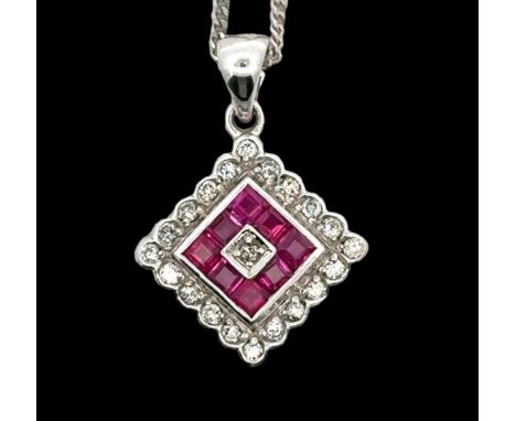 A ruby and diamond 18ct white gold pendant necklace. Hallmarks to pendant and 18"chain. Pendant 17mm in width. Weight 5.26g. 