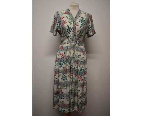 A 1940s floral cotton St Michaels day dress, having cap sleeves, buttons to front, side metal zip and pleats to skirt, to fit