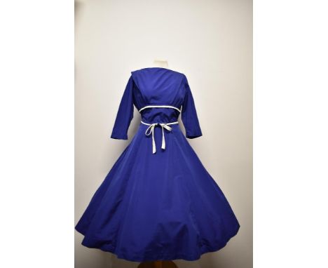 A 1950s Horrockses cotton day dress, having cobalt blue ground with contrasting white pique tie to under bust, 3/4 sleeves an