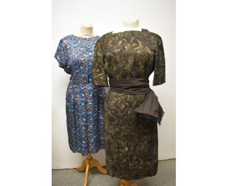 An early 1960s brown abstract patterned dress, having sash to waist, larger size, also included is a 1960s dress with blue an