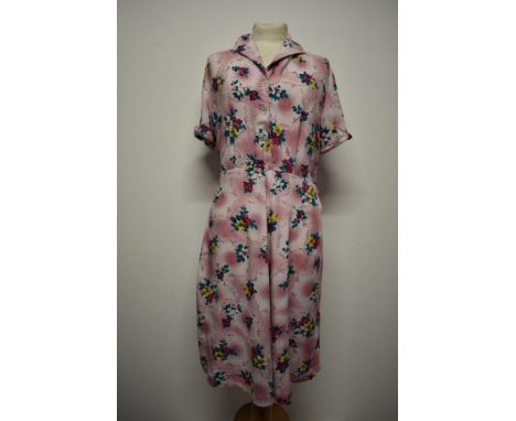 A 1940s floral cotton day dress, having button down front and side press stud fastening, large size.