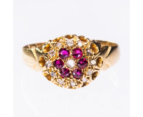 A LATE 19TH CENTURY 18CT YELLOW GOLD RUBY RING, the pierced detail circular mount set with ruby and diamond highlights betwee