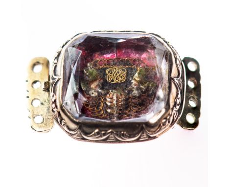 A STUART ERA CRYSTAL CLASP, the foil backed mount with regal tapestry set beneath crystal. Width 2cm. Weight 3.2gms.&nbsp;