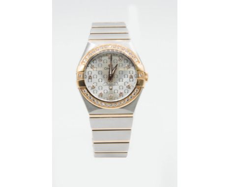 A LADY'S OMEGA CONSTELLATION DIAMOND SET BRACELET WATCH. Circular silver grey tapestry dial with Omega symbol throughout, dia