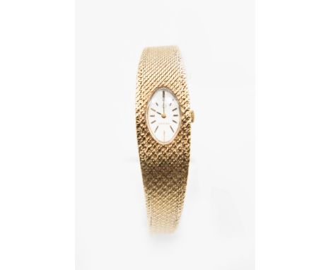 A LADY'S 9CT GOLD OMEGA BRACELET WATCH.&nbsp;&nbsp;Oval silver dial with baton index and black hands set in textured Milanese
