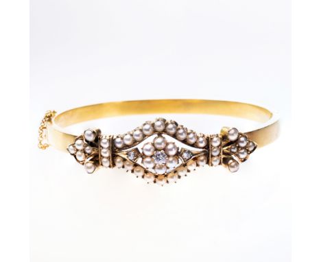 A MID 19TH CENTURY SEED PEARL SET BANGLE, the navette shaped mount with scroll details set throughout with graduating seed pe
