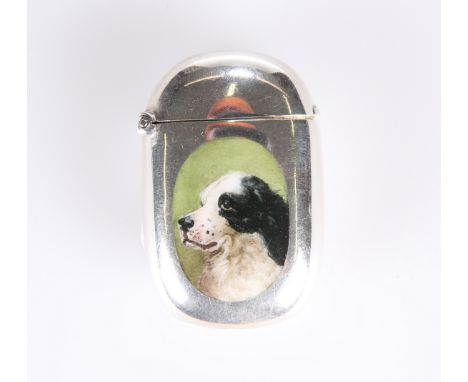 A LATE VICTORIAN SILVER AND ENAMEL VESTA CASE DECORATED WITH A SPANIEL'S HEAD, with import marks for Birmingham 1894, of shap
