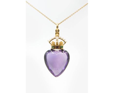 A VICTORIAN AMETHYST PENDANT, the large cabochon heart shaped amethyst set beneath a crown shaped mount set with seed pearls,