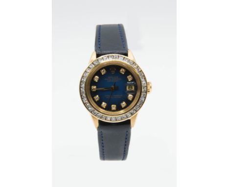 A LADY'S 18ct GOLD ROLEX OYSTER WATCH WITH DIAMOND BEZEL. Circular blue dial with diamond set indices, gilt hands and apertur