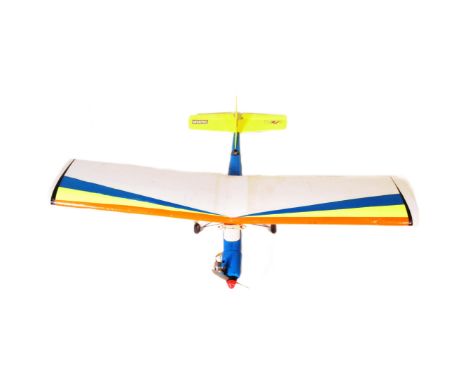 Radio Controlled Plane - a vintage model RC plane fuselage and wings. Fitted with front engine, propellers and radio gear. Wi