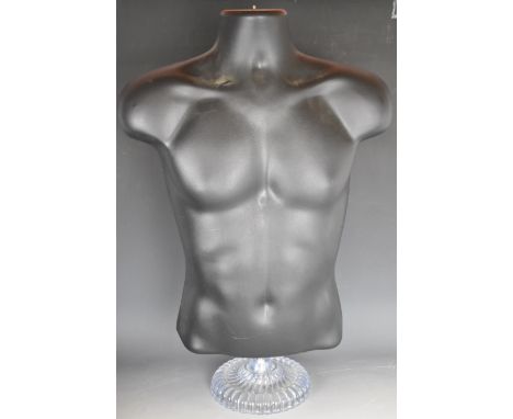 Shop display mannequin male torso raised on clear lobed plastic base, 69cm tall.&nbsp;