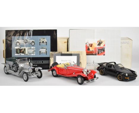 Three Franklin Mint diecast model cars comprising 1906 Rolls Royce Silver Ghost, 1935 Mercedes 500 K Special Roadster and Por