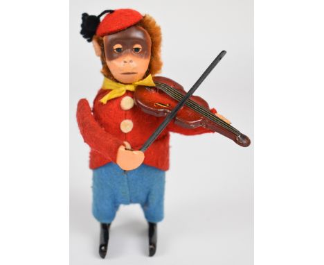 Schuco clockwork tinplate monkey in felt clothing playing a violin, stamped Made In Germany to outside of foot, height 11cm.